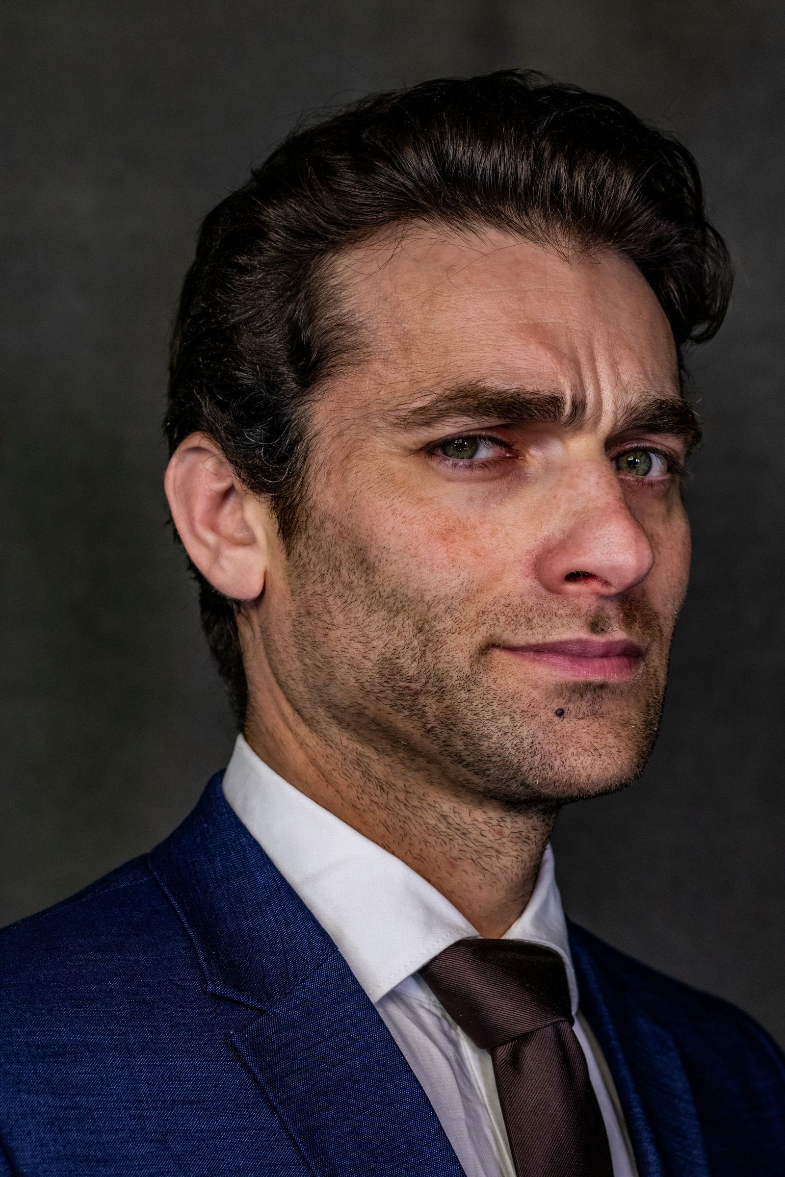 Close-up portrait of a confident businessman wearing a dark suit, exuding professionalism.